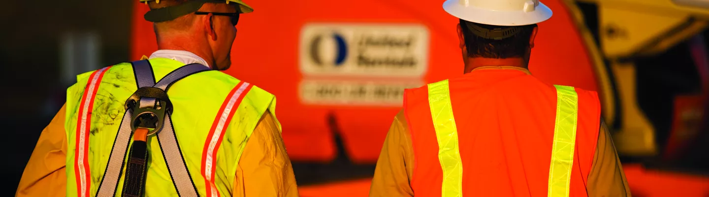 two men on jobsite wearing ppe