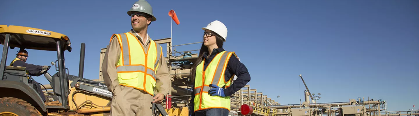man and woman on construction site in PPE 