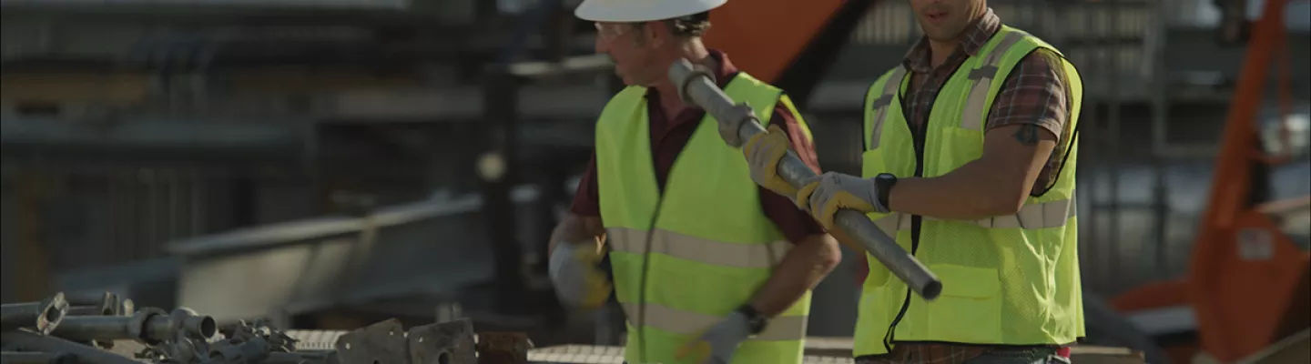 two men walking in ppe on construction site