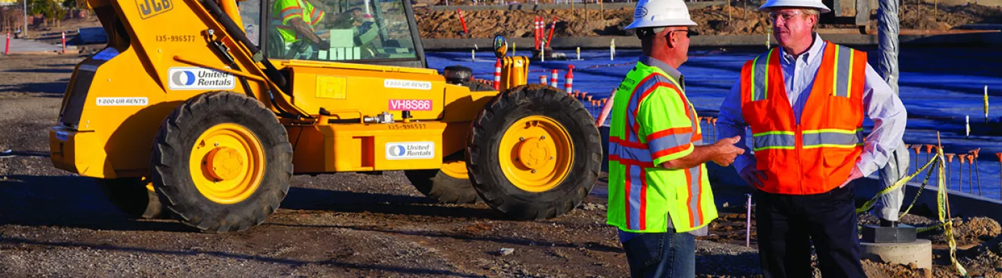 two men on construction site in PPE 