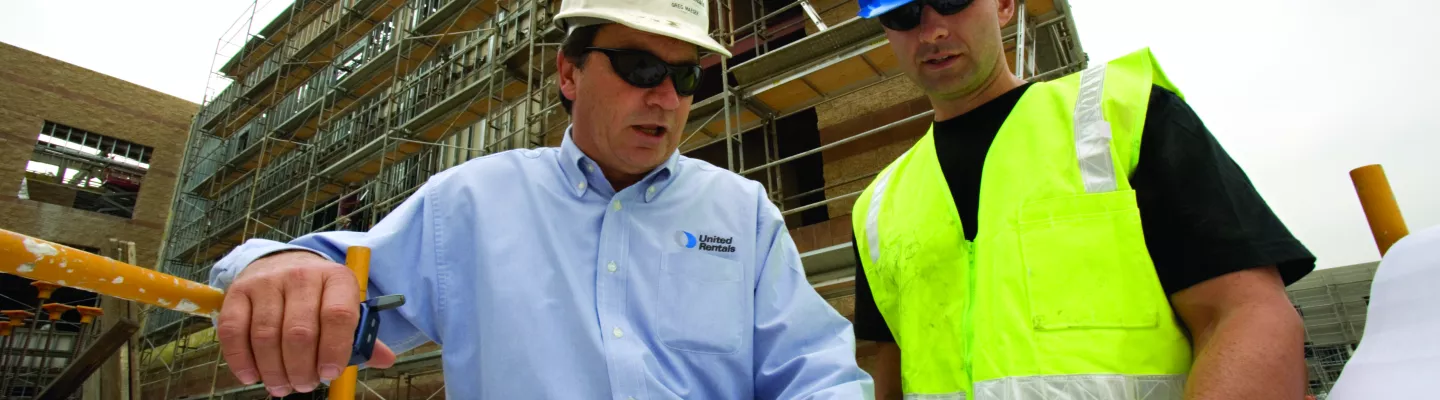 two men walking in ppe on construction site