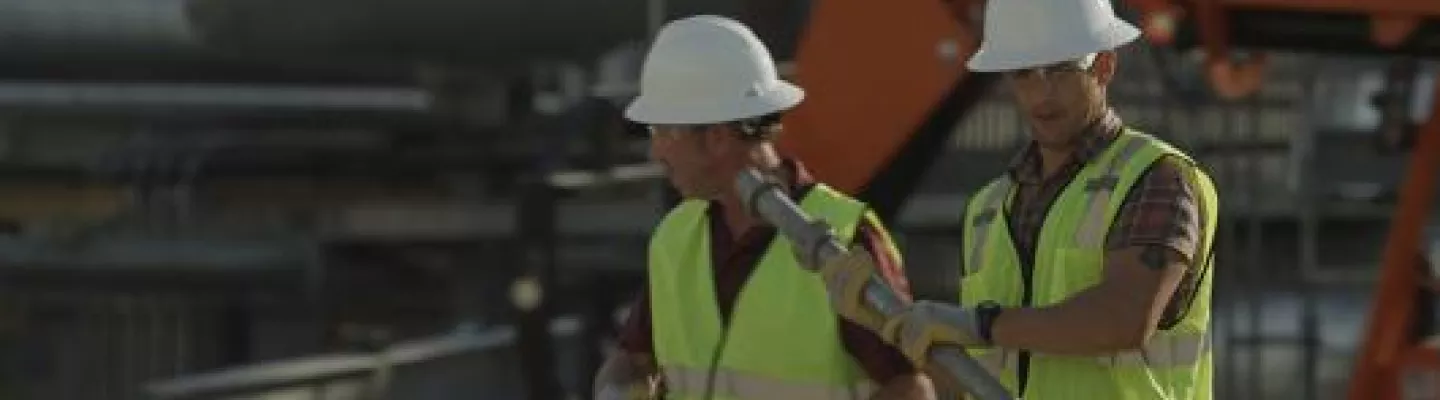 two men walking in ppe on construction site