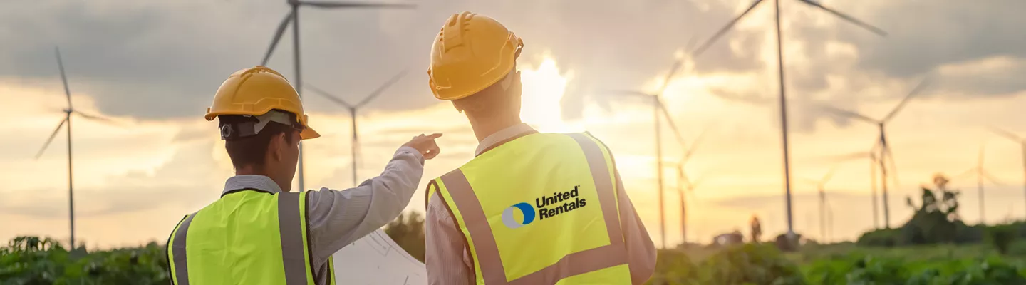 two men in safety vests on wind farm