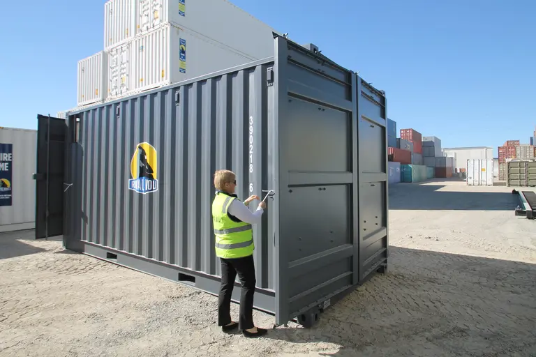 Person opening a large container door 