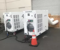 white temporary chiller systems outside a warehouse with ducting going in
