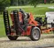 Orange Ditch Witch trailer for a walk-behind trencher with ramp upright