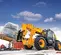 Side view of a yellow JCB telehandler with enclosed cab, retracted boom, lifting a pallet on a snowy construction site.