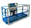 Front view of blue aerial work platform with guardrails and a control panel.