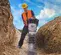 Yellow and silver Wacker-Neuson heavy-duty vibratory rammer being used to tamper soil