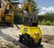 Yellow and black Epiroc Vibratory Plate Compactor Attachment for Backhoe