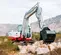 Red and white Takeuchi Mini Excavator with Reduced Tail Swing