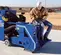 blue concrete abrasive blaster in use with a man in front of it