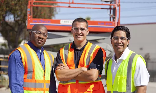 three men on jobsite in PPE