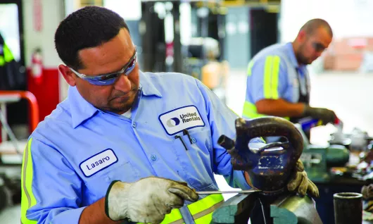 two men working in equipment shop