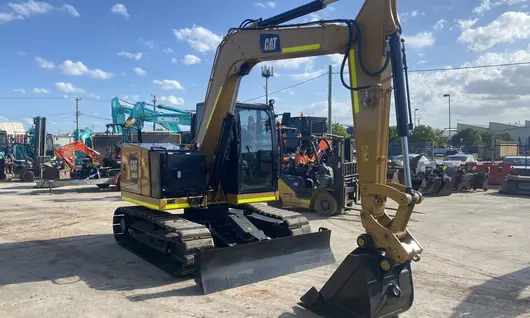 Parked excavator, positioned near safety barriers used for site control and hazard prevention.