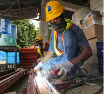 Worker in PPE working with sparks