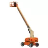 Rear angled view of an orange and beige telescopic boom lift with extended arm and basket.