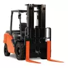 Front angled view of an orange and black Toyota warehouse forklift with a black mast, orange forks and an open cabin.