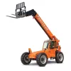 Front angled view of an orange Skytrak telehandler with an extended boom, black forklift attachment and enclosed cabin.