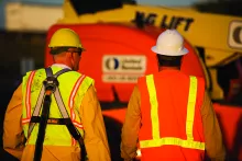 two men on jobsite wearing ppe