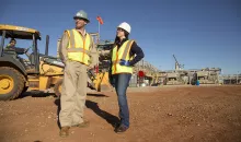 man and woman on construction site in PPE 