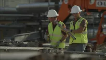 two men walking in ppe on construction site