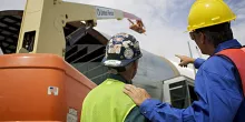 two men walking in ppe on construction site