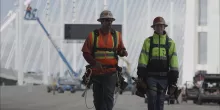 two men walking in ppe on construction site