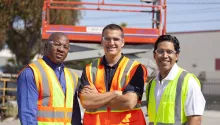 three men on jobsite in PPE