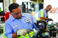 two men working in equipment shop