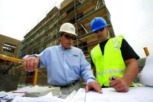 two men walking in ppe on construction site